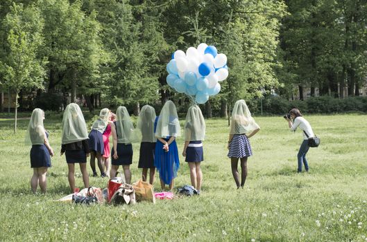 Young girls do a comic photoshoot in park of Sankt of Petersburg, Russiaю