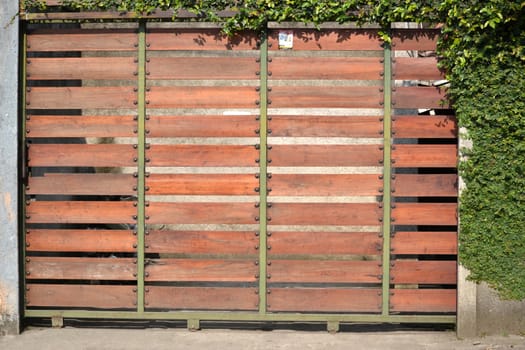 brown wooden gate with green plant as decoration