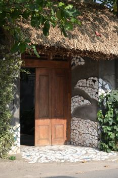 brown wooden gate with green plant as decoration