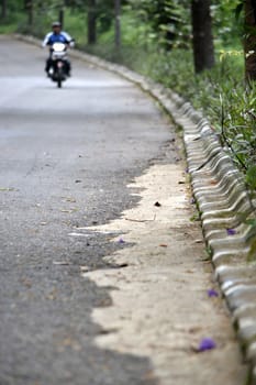 empty road with one motorcycle are going to approach