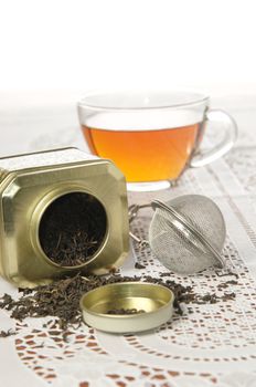 A silver spoon next to two jars of tea