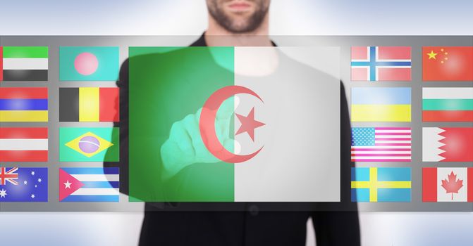 Hand pushing on a touch screen interface, choosing language or country, Algeria