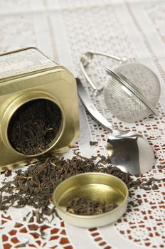 A silver spoon next to two jars of tea