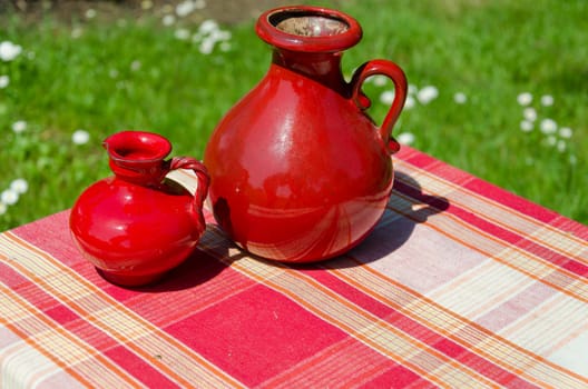 large and small red retro vintage clay jugs outdoor