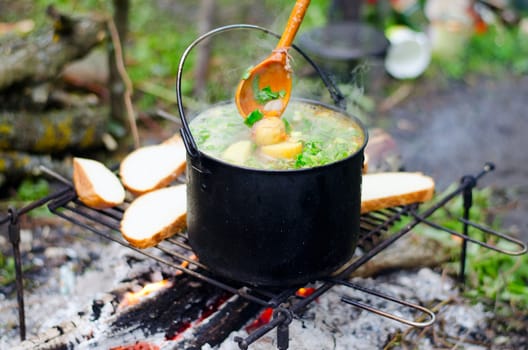 Preparation of potatoes in a pot on the fire