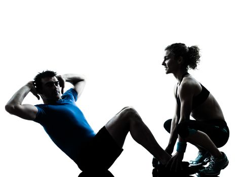 one  couple man woman personal trainer coach exercising abdominal silhouette studio isolated on white background