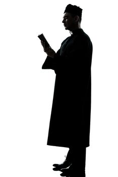 one  man priest reading bible silhouette in studio isolated on white background
