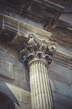 Volute, Corinthian capitals, stone columns in old building in Spain