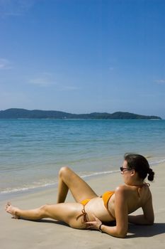 Sunbathing Woman portrait on a tropical beach