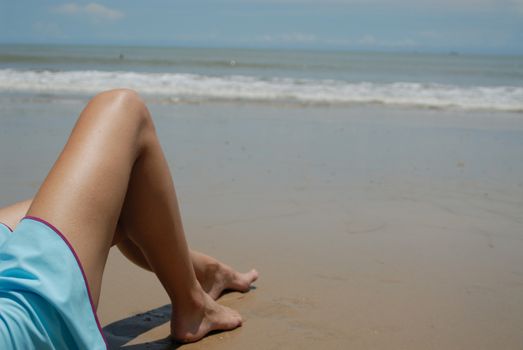 Stock photo of beautiful tall brunette woman on the beach in the tropics