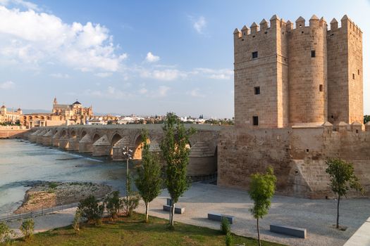 Roman bridge with  Calahorra Tower and Grand Mosque on background in Cordoba, Andalusia, Spain
