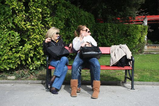 Tourists resting and enjouing on the bench