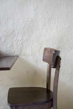 A table and chair set against a wall in a cafe, Melaka, Malaysia