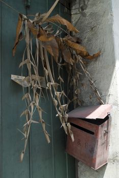 Dried grasses hung in an old doorway in Melaka, Malaysia