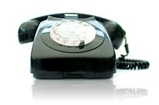Vintage telephone over a white background
