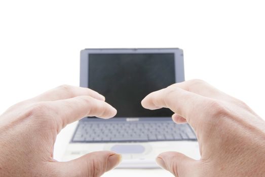 Large Hands preparing to use a laptop in the distance