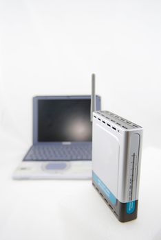 A modern silver laptop with wireless router