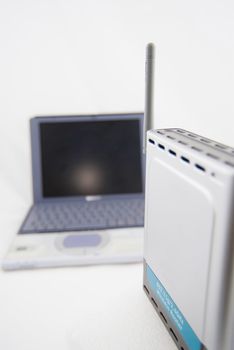 A modern silver laptop with wireless router