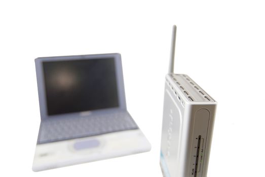 A modern silver laptop with wireless router