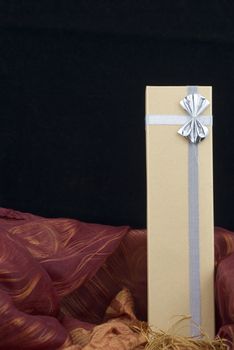 Christmas gift with silver bow on black background