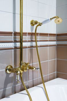 The beautiful bronze faucet and white bath