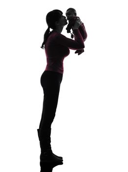 one caucasian woman holding kissing baby silhouette on white background