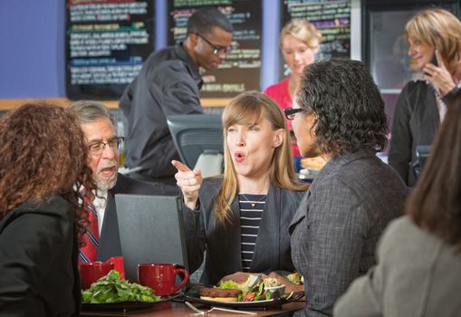 Group of business people arguing in cafeteria