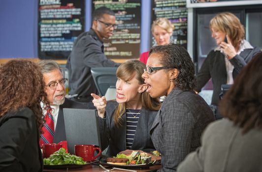 Arguing business people with computer bickering over lunch