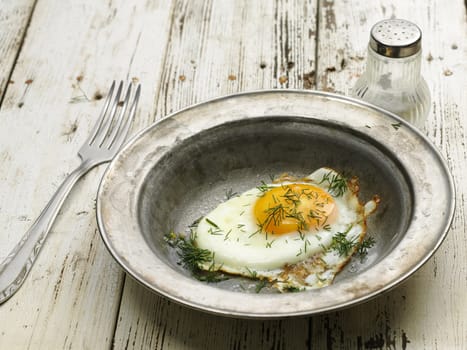 tasty homemade fried egg on the steel plate
