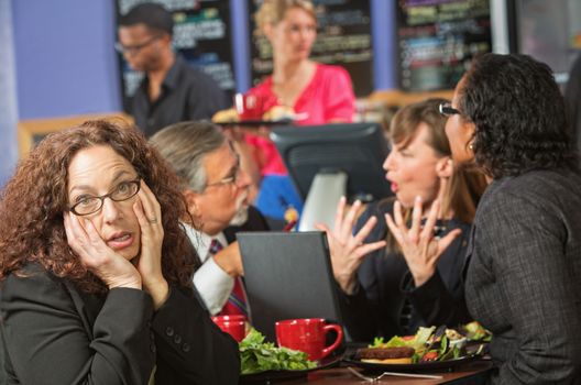 Bored woman with coworkers at lunch break