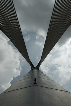 Modern Architctureal style bridge abstracts angainst a cloudy sky
