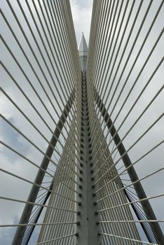 Modern Architctureal style bridge abstracts angainst a cloudy sky
