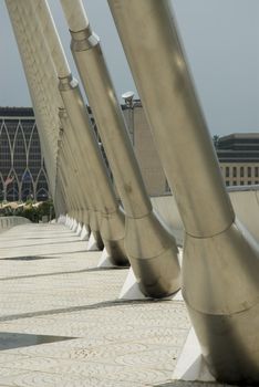 Modern Architctureal style bridge abstracts angainst a cloudy sky
