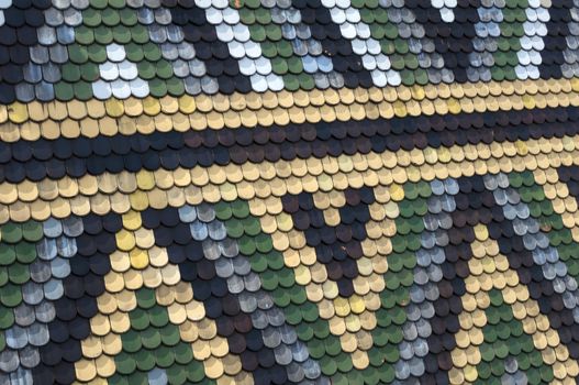 Detailed view of colorful wooden roof shingles.