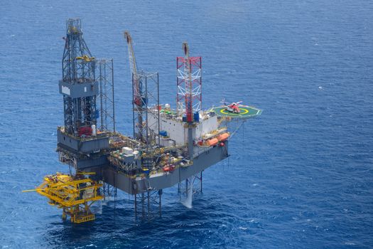 Top view of helicopter pick up passenger on the offshore oil rig