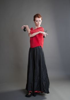 flamenco dancer swinging skirt on a grey background