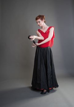 flamenco dancer swinging skirt on a grey background