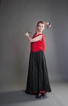 flamenco dancer swinging skirt on a grey background