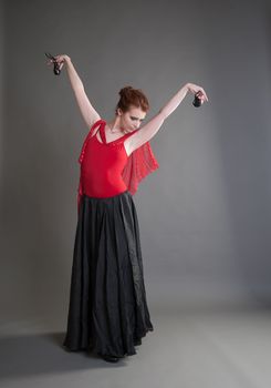 flamenco dancer swinging skirt on a grey background