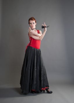 flamenco dancer swinging skirt on a grey background