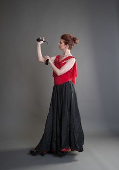 flamenco dancer swinging skirt on a grey background