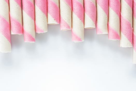 Closeup pink stripe wafer rolls on white Background .