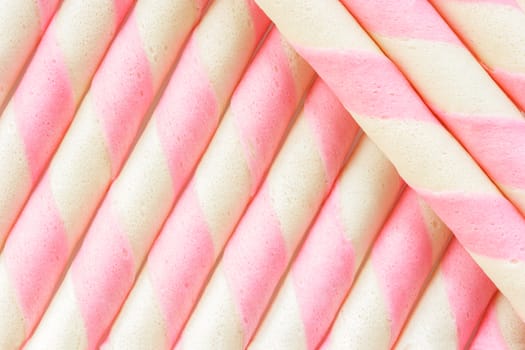 Closeup pink stripe wafer rolls Background .