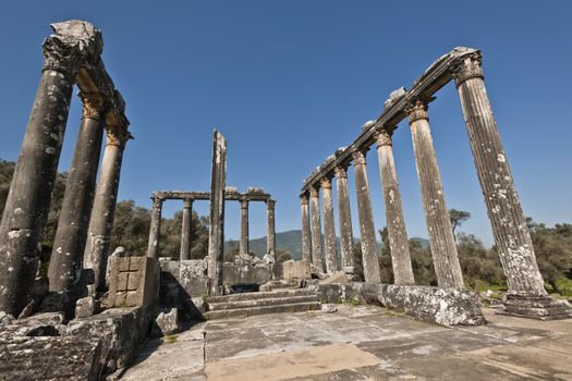 The Temple of Zeus at Euromos is to me the perfect ruined Greek temple.  Set in a forest of olive trees just east of the D525 highway between Selcuk (Ephesus) and Bodrum (25 km/16 miles SE of Lake Bafa, 13 km/8 miles NW of Milas), just south of the village of Selimiye (map), the Corinthian temple almost looks like a Hollywood set, except it's for real.  A shrine may have existed here from the 6th century BCE.  Believed to date from the time of Emperor Hadrian (117-138 CE), the Temple of Zeus Lepsynus and its precinct were excavated by Turkish archeologists starting in 1969. Look carefully and you'll see that some of the columns are unfluted, meaning perhaps that the temple was never finished.  Located about a mile south of the village of Selimiye, the temple area has no services, although there may be a villager selling cold drinks.  Stop for a half-hour's look if you're driving south from ?zmir or Ephesus headed for Milas, Bodrum or Marmaris.  This is actually a much larger archeological site than just the temple. The hillside to the east is littered with ruins, and if you spend an hour hiking around you can find a theater, an agora and massive defensive walls.