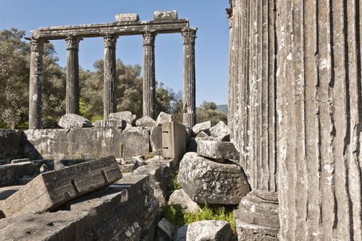 The Temple of Zeus at Euromos is to me the perfect ruined Greek temple.  Set in a forest of olive trees just east of the D525 highway between Selcuk (Ephesus) and Bodrum (25 km/16 miles SE of Lake Bafa, 13 km/8 miles NW of Milas), just south of the village of Selimiye (map), the Corinthian temple almost looks like a Hollywood set, except it's for real.  A shrine may have existed here from the 6th century BCE.  Believed to date from the time of Emperor Hadrian (117-138 CE), the Temple of Zeus Lepsynus and its precinct were excavated by Turkish archeologists starting in 1969. Look carefully and you'll see that some of the columns are unfluted, meaning perhaps that the temple was never finished.  Located about a mile south of the village of Selimiye, the temple area has no services, although there may be a villager selling cold drinks.  Stop for a half-hour's look if you're driving south from ?zmir or Ephesus headed for Milas, Bodrum or Marmaris.  This is actually a much larger archeological site than just the temple. The hillside to the east is littered with ruins, and if you spend an hour hiking around you can find a theater, an agora and massive defensive walls.