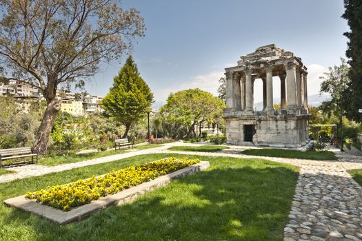 The Mausoleum lies in the Street of  gumuskesen and is well known for being a Roman version of the Halikarnassos Mausoleion, which was recognized as one of the seven wonders of the ancient era. Since the Mausoleum was constructed on the most attractive site in the Roman Necropolis, there was a principle that forced the owner of the building to be an important person for the city. Namely, the owner of this place was expected to be a noble man, a manager or a person recognized as the member of a royal family. This mausoleum, being an exemplary construction thanks to the embellishing stonemasonry and the plan schedule, was constructed in the 2nd century AD, when the Antonins were ruling over Rome. The mausoleum consists of three divisions: (1) the ground floor that serves as a funerary chamber, (2) the second floor that represents the peristillium and the (3) pyramidal top floor. The walls of the ground floor consist of perfectly caved large marble blocks. The coating style of the gate in this construction is based on the same coating technique that was used for the Baltali Gate. The roof of the mausoleum was enriched from one end until the other thanks to relief plants and flowers and geometric motives. People make effort so that the gumuskesen Mausoleum, which represents the Roman Period, takes its place in the ‚ÄúWord Heritage List‚Äù that has been prepared by UNESCO.