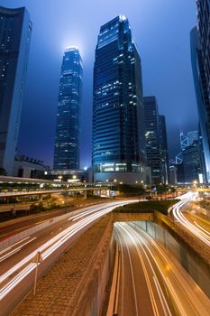 City night scene with cars motion blurred light in Hong Kong, Asia.