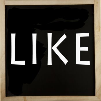 Word "Like" written with chalk over a blackboard