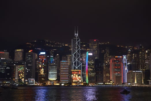 Illuminated office buildings lining the edge of Victoria Harbour in Hong Kong