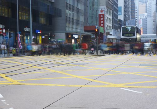 Crowds of crossing a busy road junction on Hong Kong Island in Hong Kong